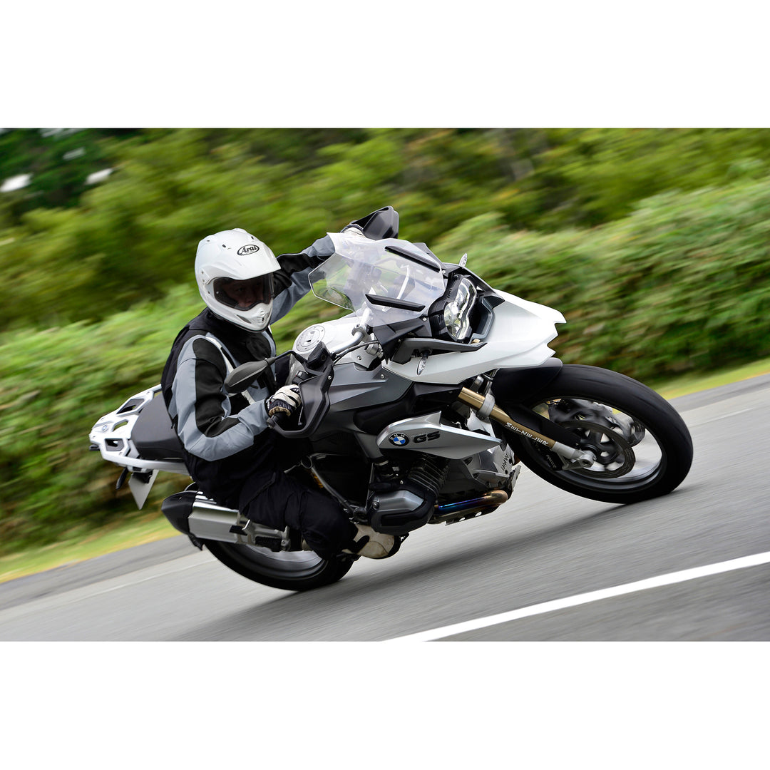 Arai XD-4 Solid Helmet White - Lifestyle Shot of Rider in helmet on gray adventure motorcycle