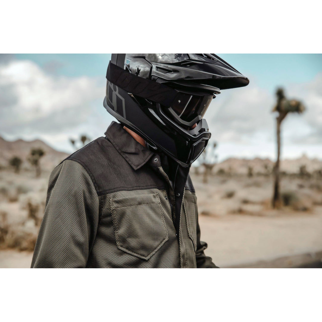 ICON Airflite™ Helmet Peak Black - Lifestyle Shot of Rider Wearing Helmet with Peak in the Desert