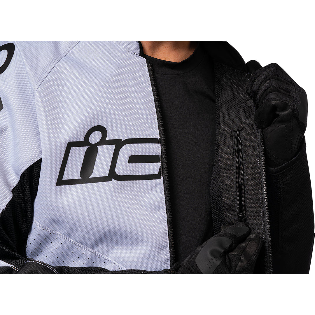 ICON Hooligan™ CE Jacket White - Close-Up of Model Unzipping Interior Pocket