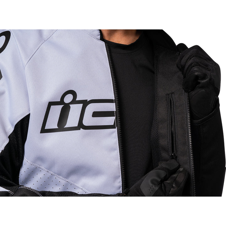 ICON Hooligan™ CE Jacket White - Close-Up of Model Unzipping Interior Pocket