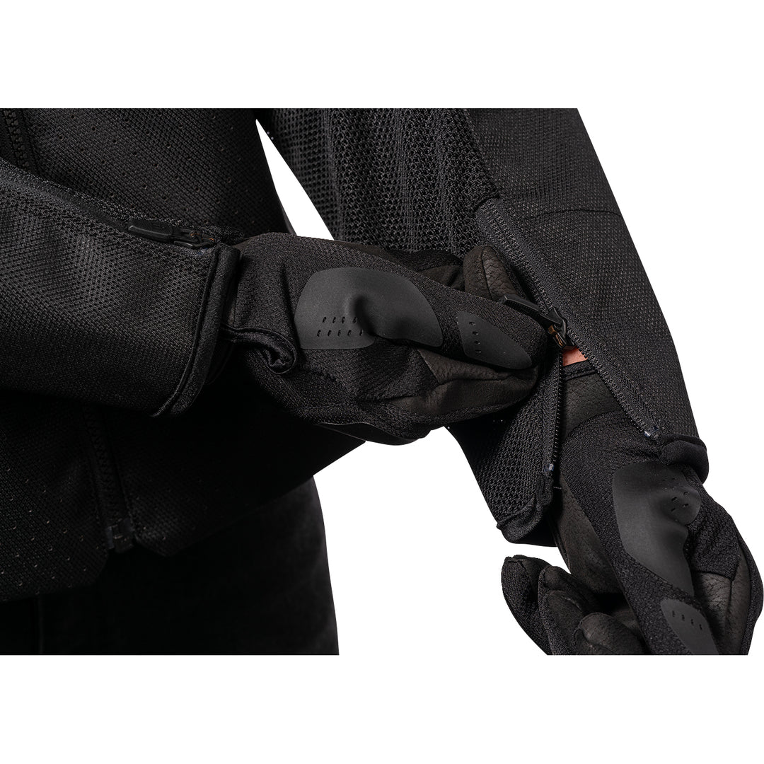 ICON Hooligan™ CE Jacket Black - Close-Up of Model Zipping Wrist Zipper