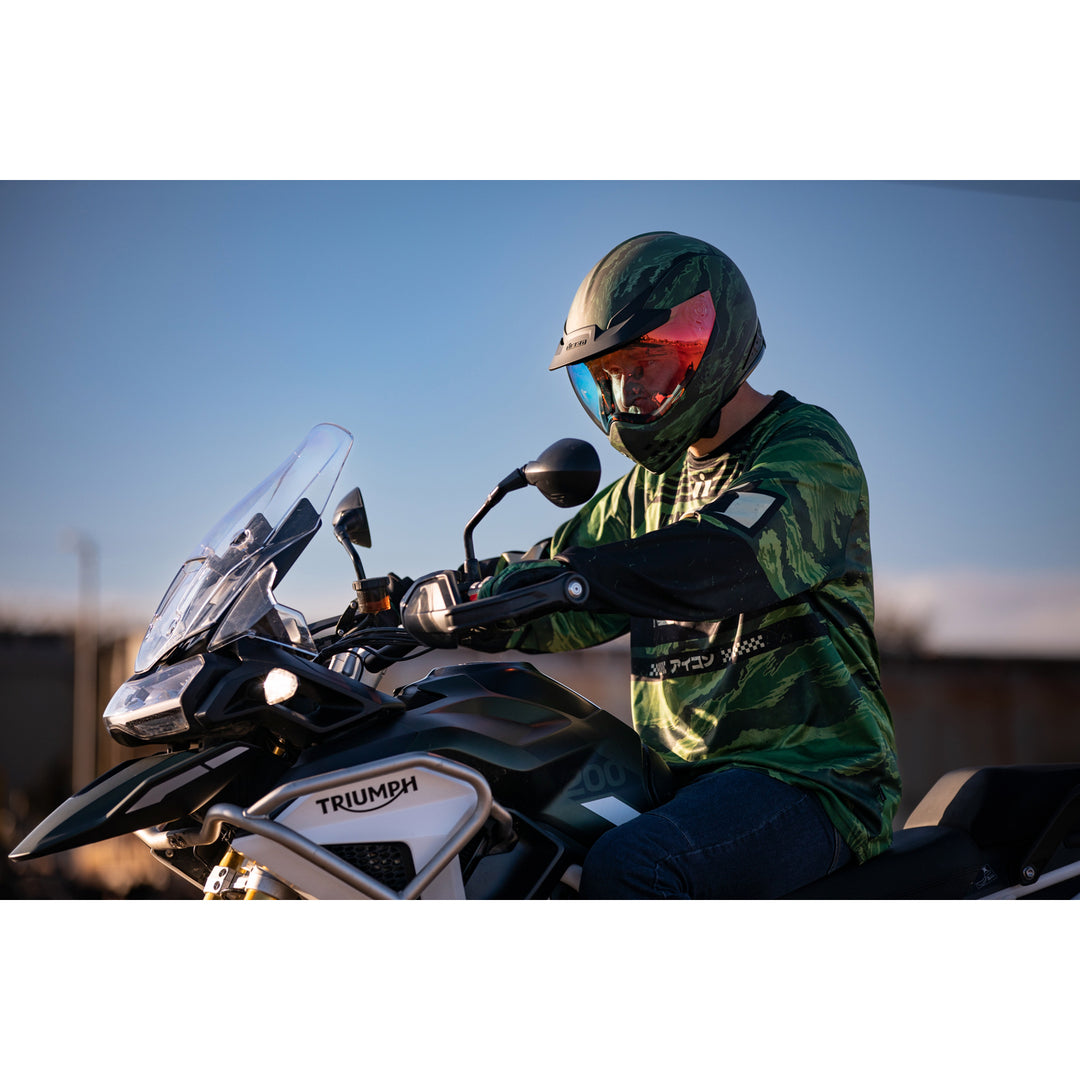 ICON Domain™ Tiger's Blood Helmet Green - Lifestyle of Rider Wearing Helmet on Dual Sport Motorcycle