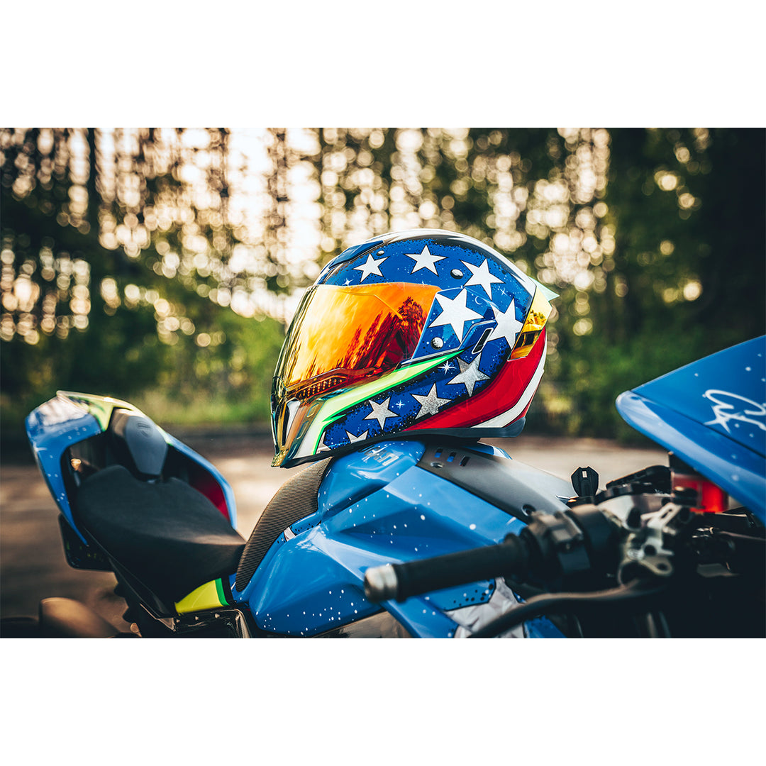 ICON Airflite™ Space Force Helmet Glory - Lifestyle Shot of Helmet Resting on Motorcycle Tank