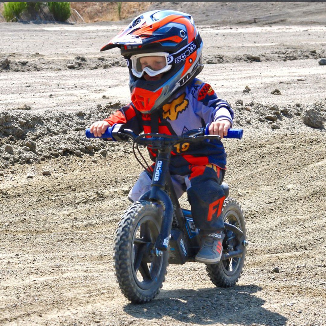 Stacyc Electric Bikes Stacyc 12EDRIVE - Lifestyle of Toddler Rider on Dirt Track