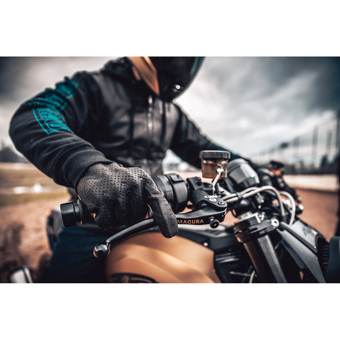 ICON Airform™ CE Gloves Black - Lifestyle Close-Up of Gloved Hand on Motorcycle Grip with One Finger Over Clutch Lever