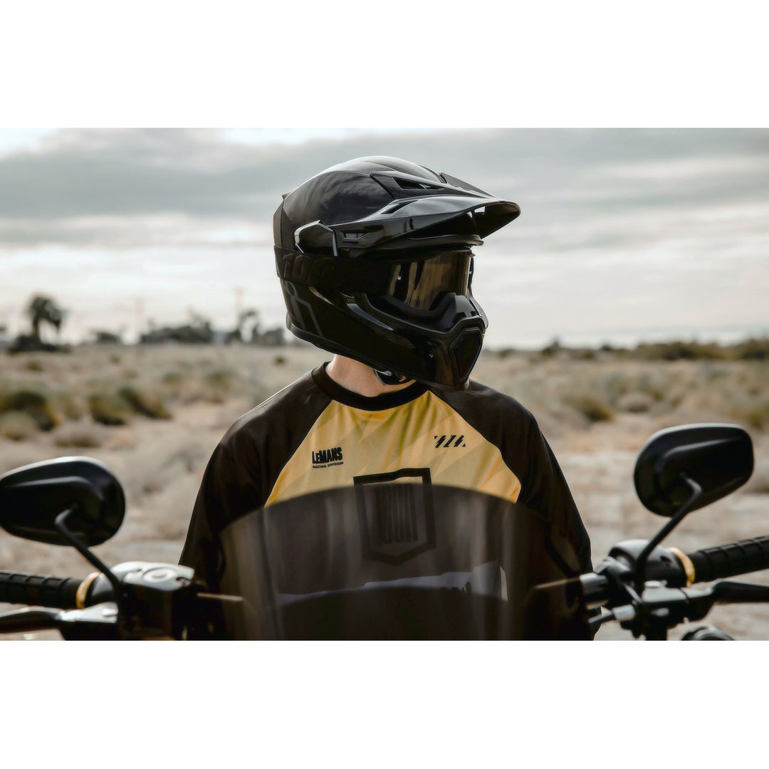 ICON Airflite™ Helmet Peak Black - Lifestyle Shot of Rider in the Desert Wearing Helmet with Peak