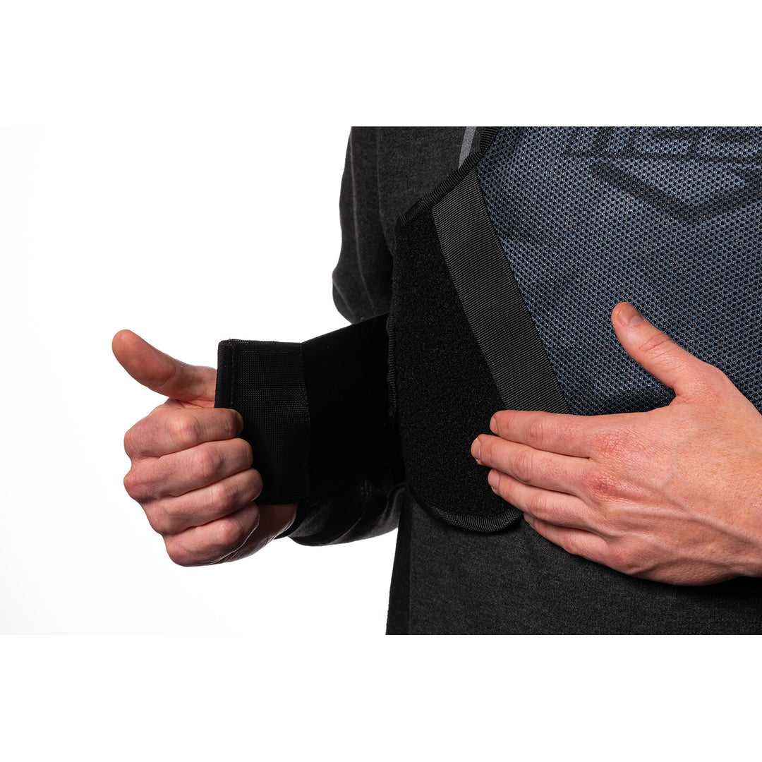 ICON Field Armor Softcore™ Vest Dark Camo - Close-Up of Model Adjusting Lower Chest Strap